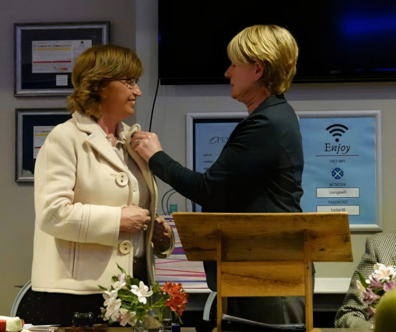 Incoming Captain, Caroline Mansley receiving her brooch